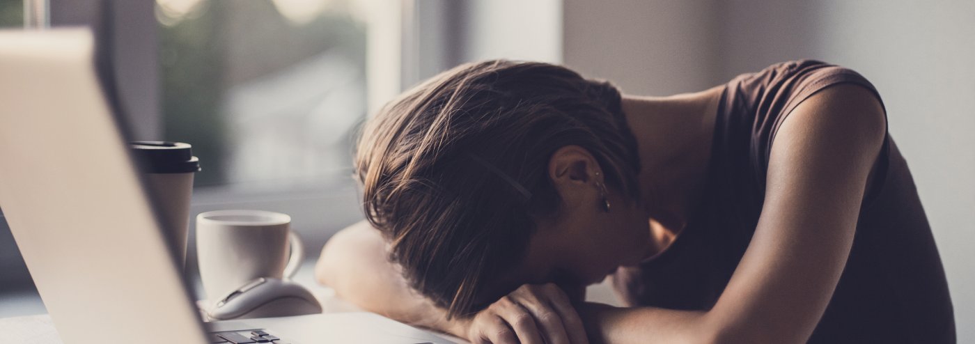 Exhausted student in front of laptop